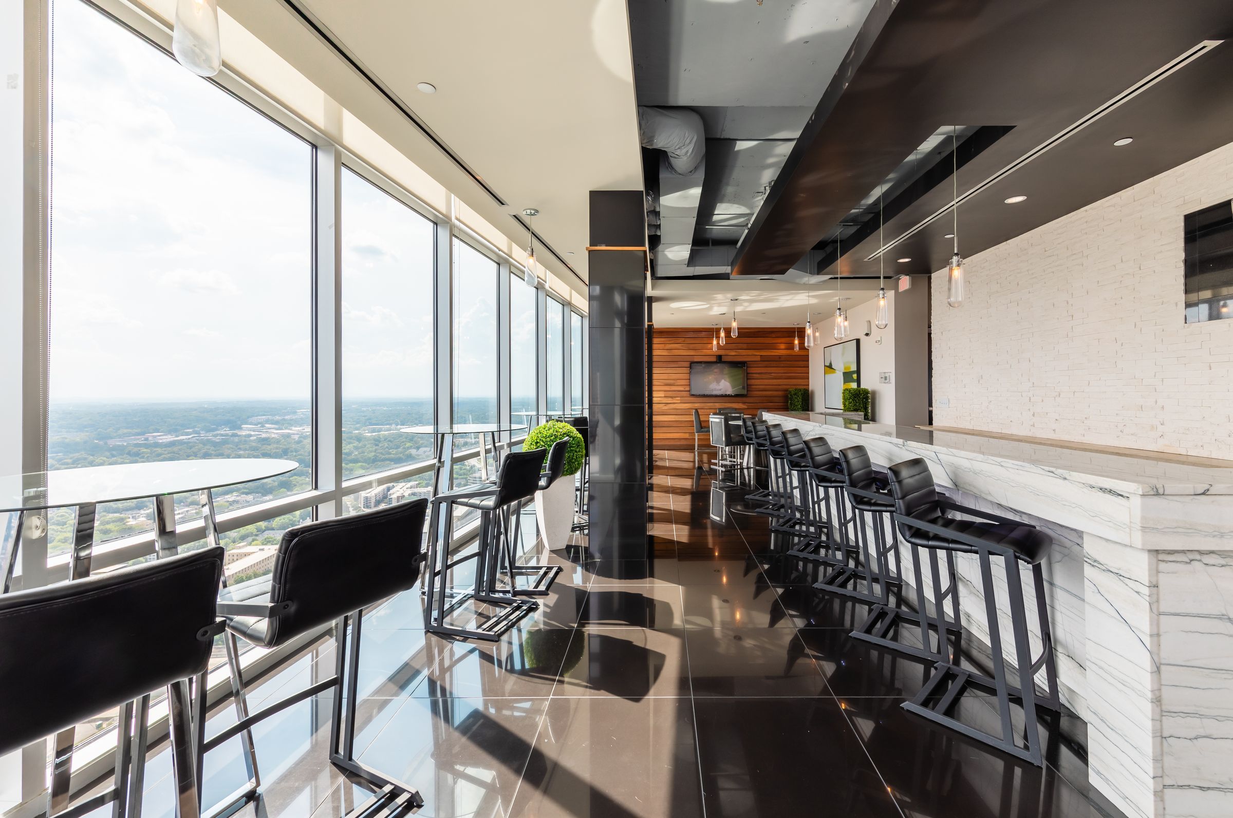 The Vue Charlotte Sky Bar with floor to ceiling windows and views of the city, including abundant seating and lounge area