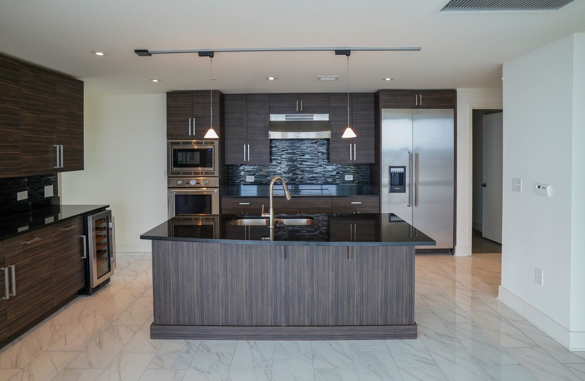 Luxury apartment kitchen with stainless steel appliances, granite countertops, and lots of storage space