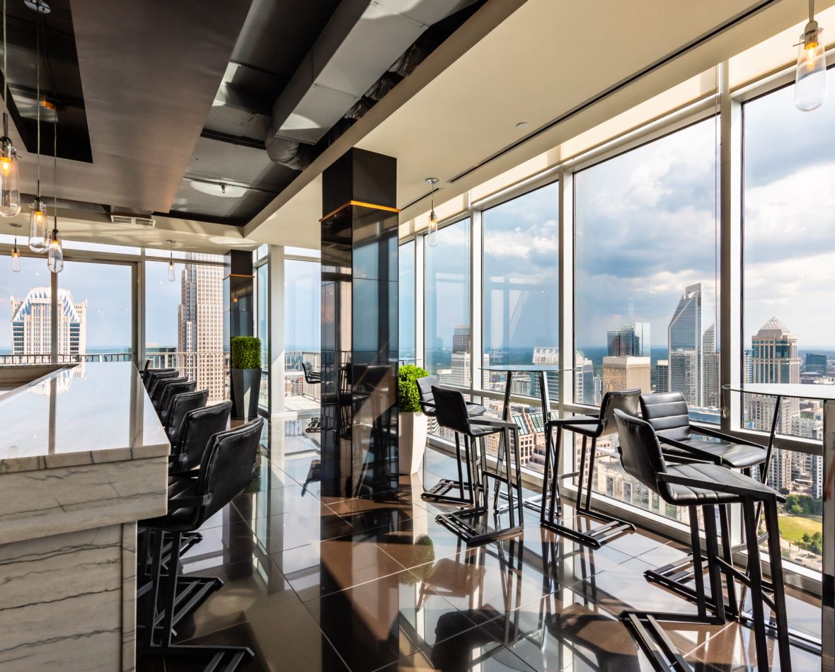 Sky Lounge at The VUE Charlotte high rise apartments overlooking the city at dusk