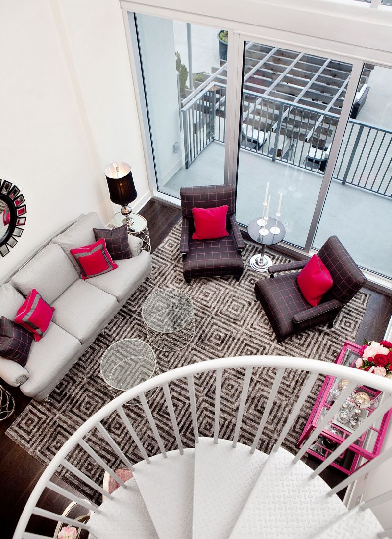 The Vue Charlotte apartment with dramatic spiral staircase looking down at living room