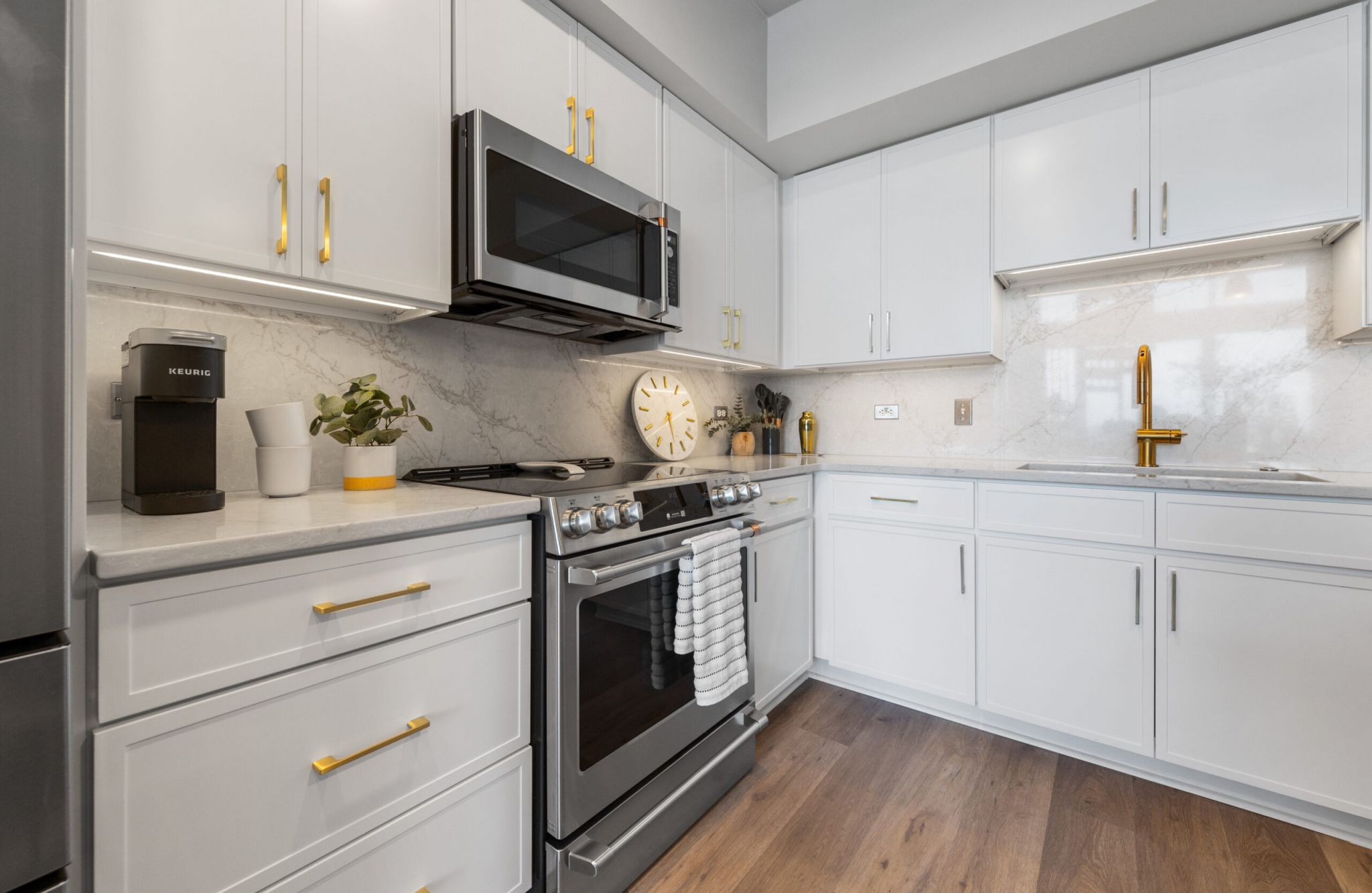The Vue at Charlotte, NC apartment kitchen with kitchen island, granite countertops, bar stools, and stainless steel appliances
