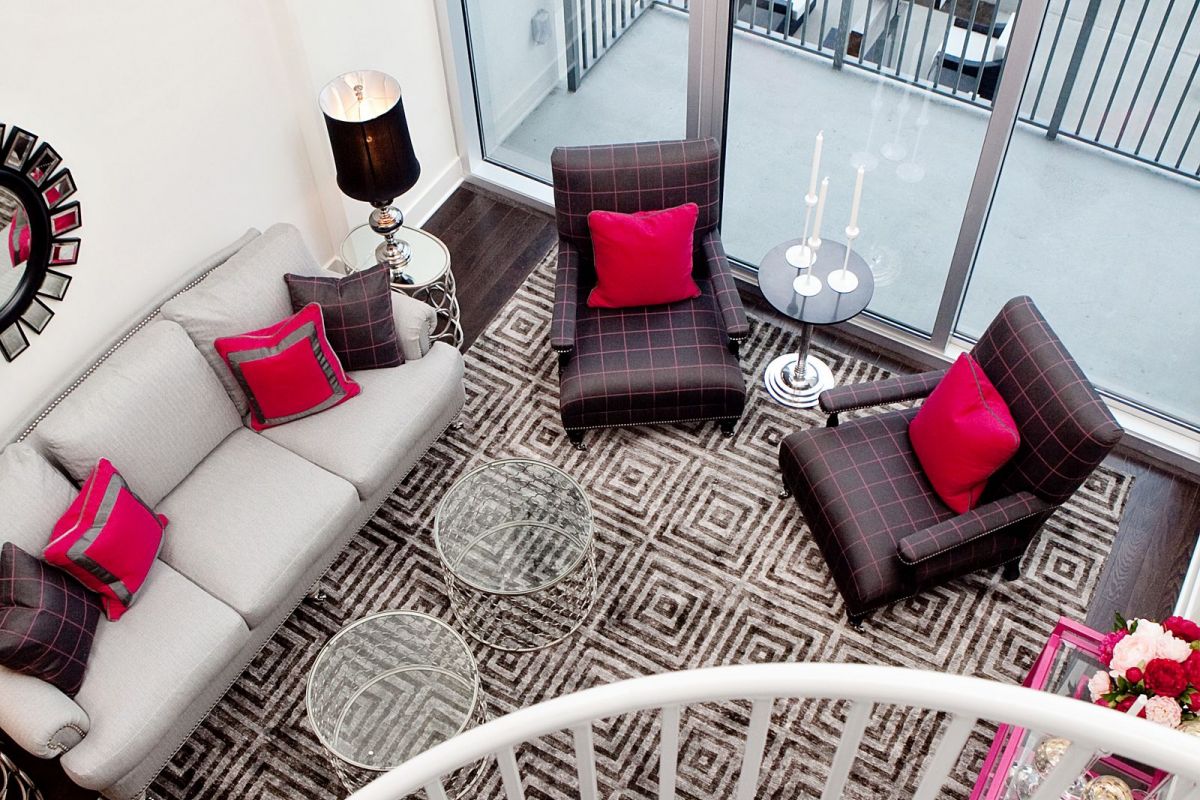 The Vue Charlotte apartment with dramatic spiral staircase looking down at living room
