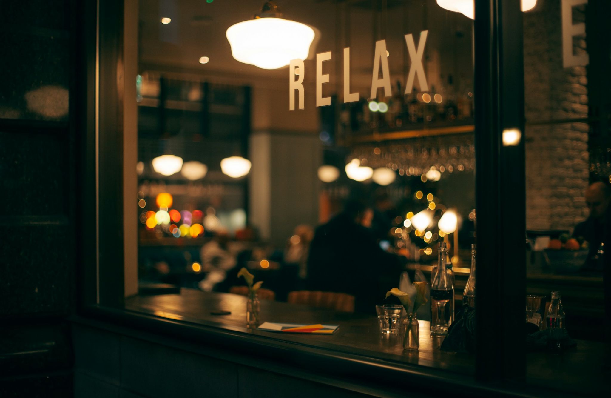 The Vue Charlotte apartment neighborhood night lounge with relax sign on the window